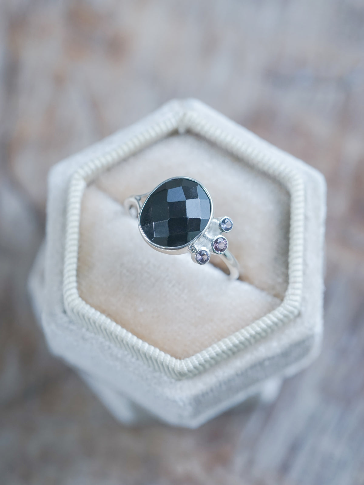 The Black Onyx and 3 Purple Spinel Ring in velvet box