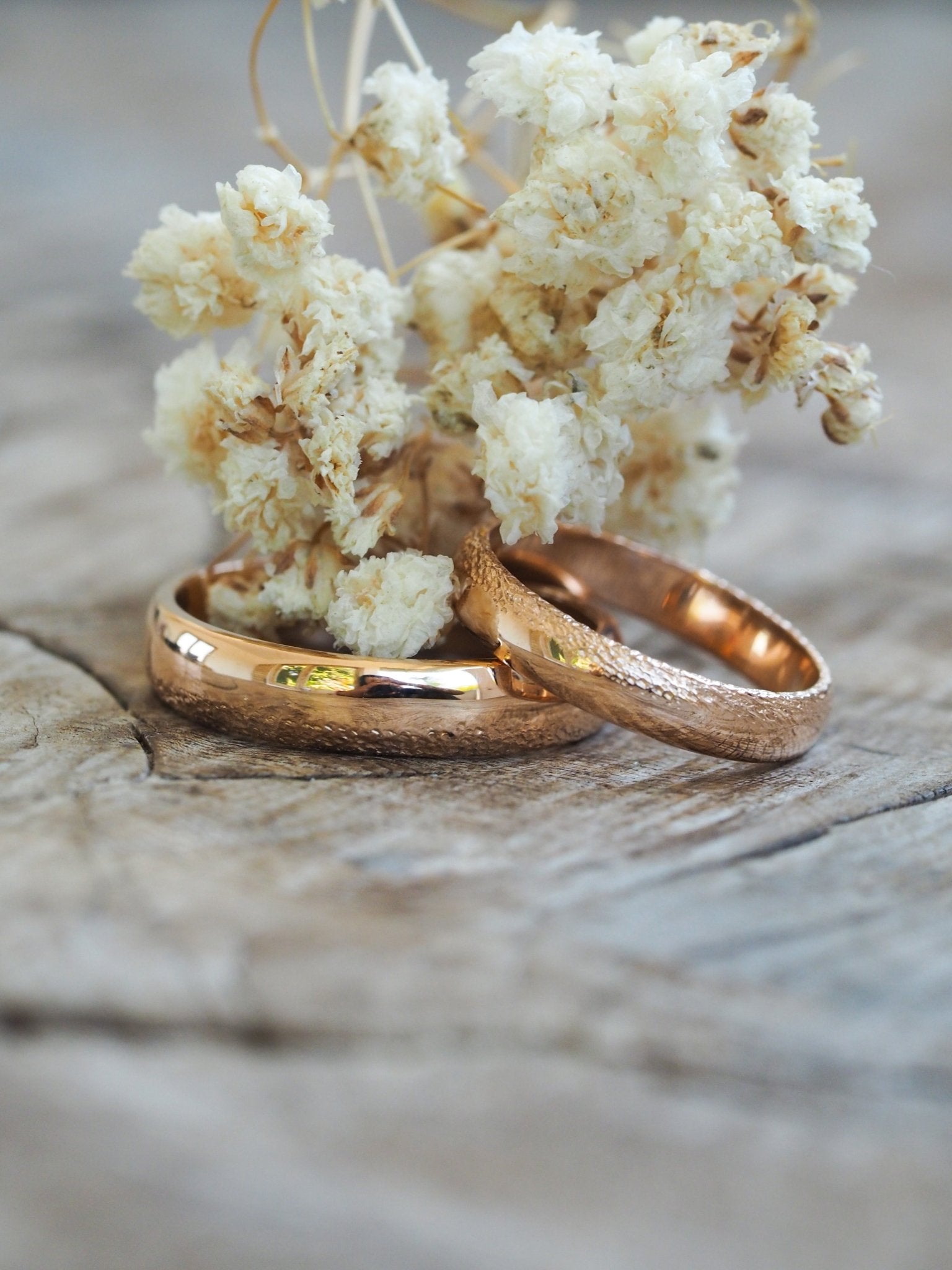 Premium Photo | A pair of gold wedding rings with a diamond ring on the  left.